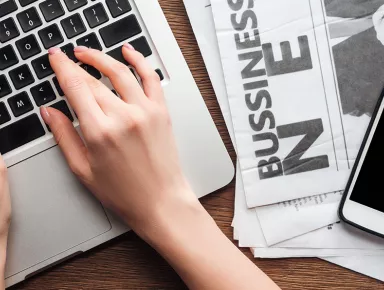 cropped image of a journalist working on a laptop computer