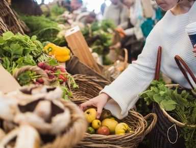 Une femme faisant les courses devant un étal de marché