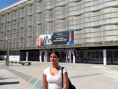 Picture of a student posing in front of the Audencia Atlantic campus