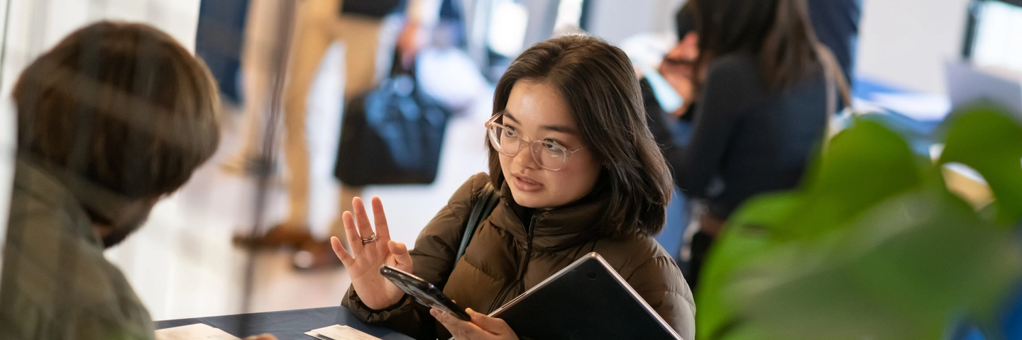 A student being interviewed at a company forum