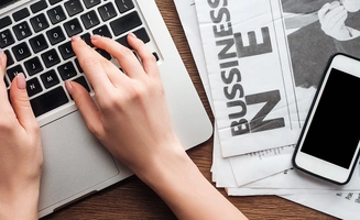 cropped image of a journalist working on a laptop computer