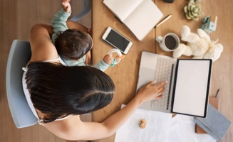 woman working at home with infant child