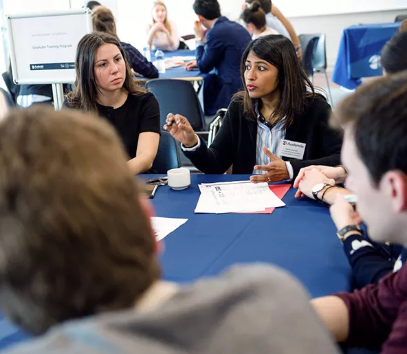 Audencia - Students debating around a table